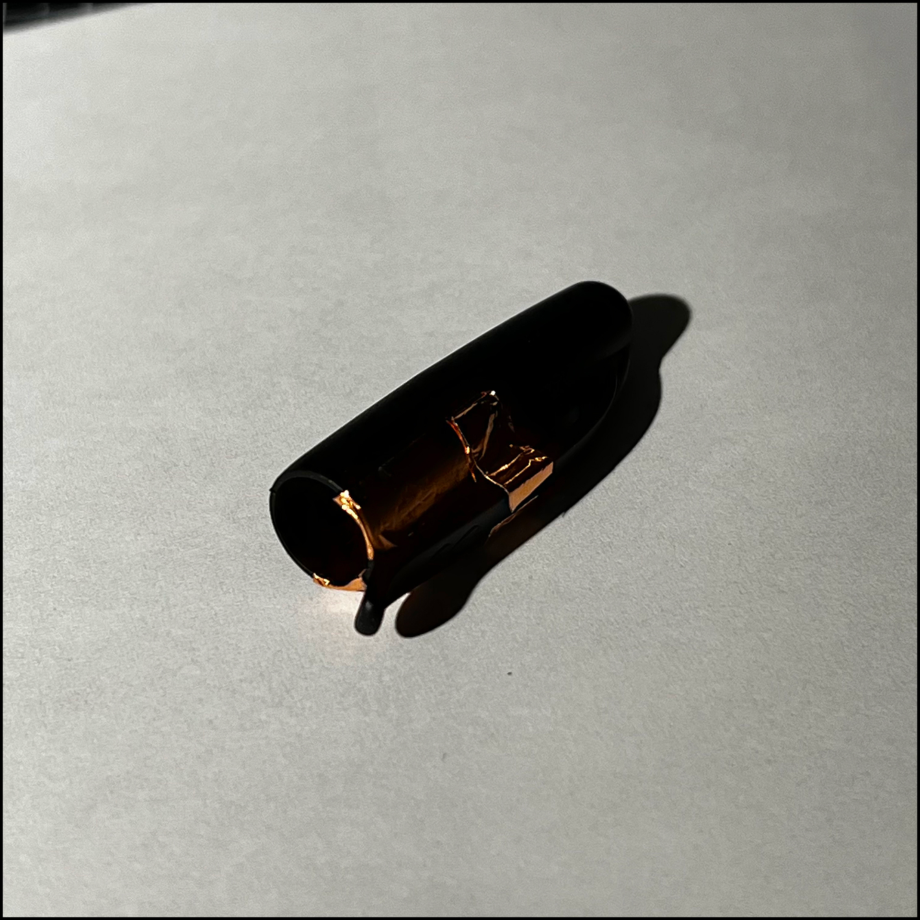Another view of the copper tape placed on the cap. Can see the inside where the tape wraps the edge of the cap so there is a touch point when the pen is attached to the cap.
