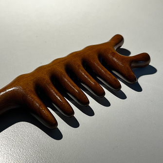 photo of a wooden massage hair brush