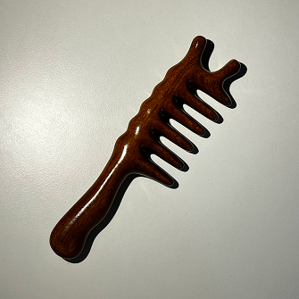 photo of a wooden massage hair brush